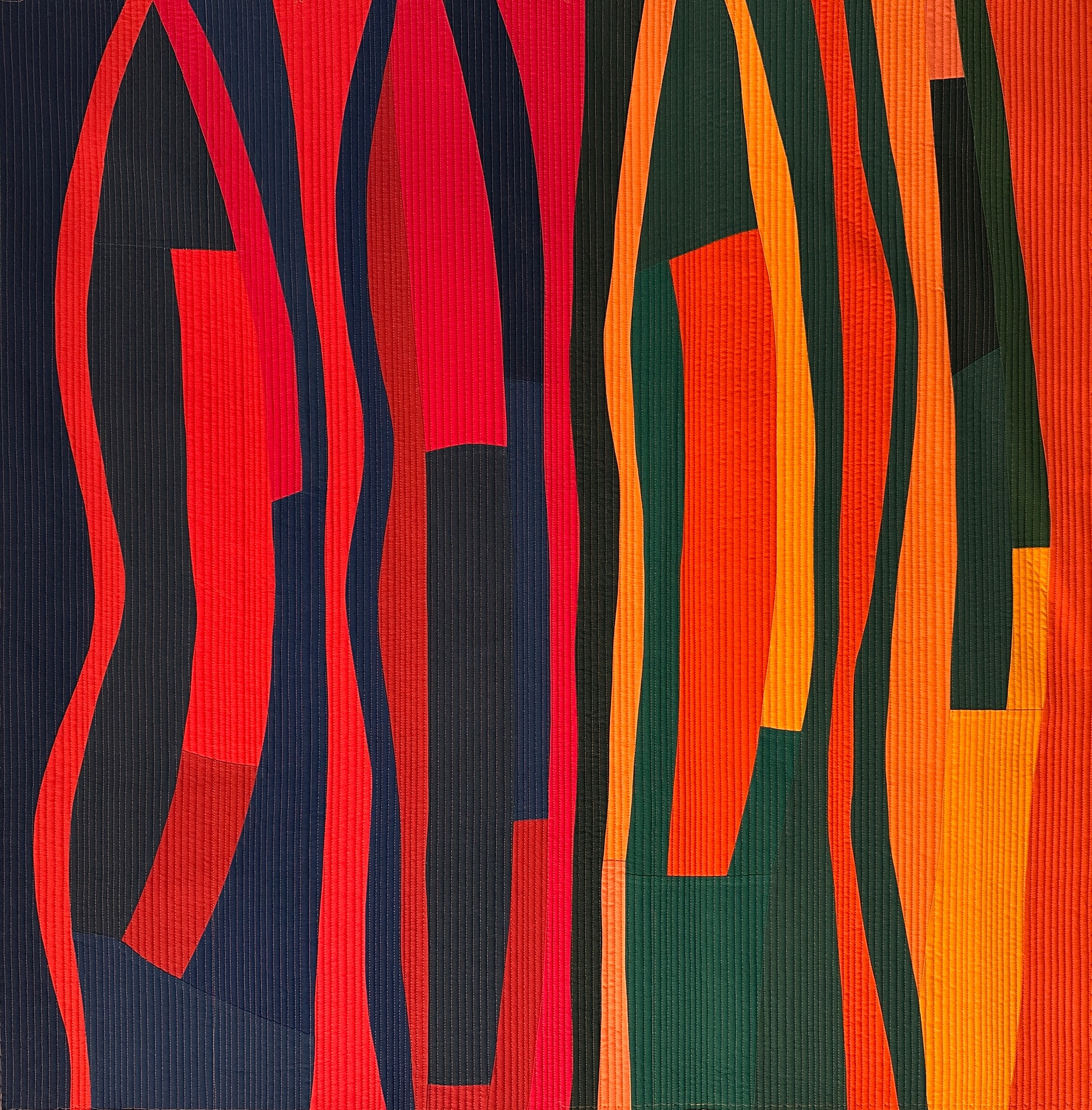 Abstract art quilt with wavy lines in red, orange, and black on a textured background