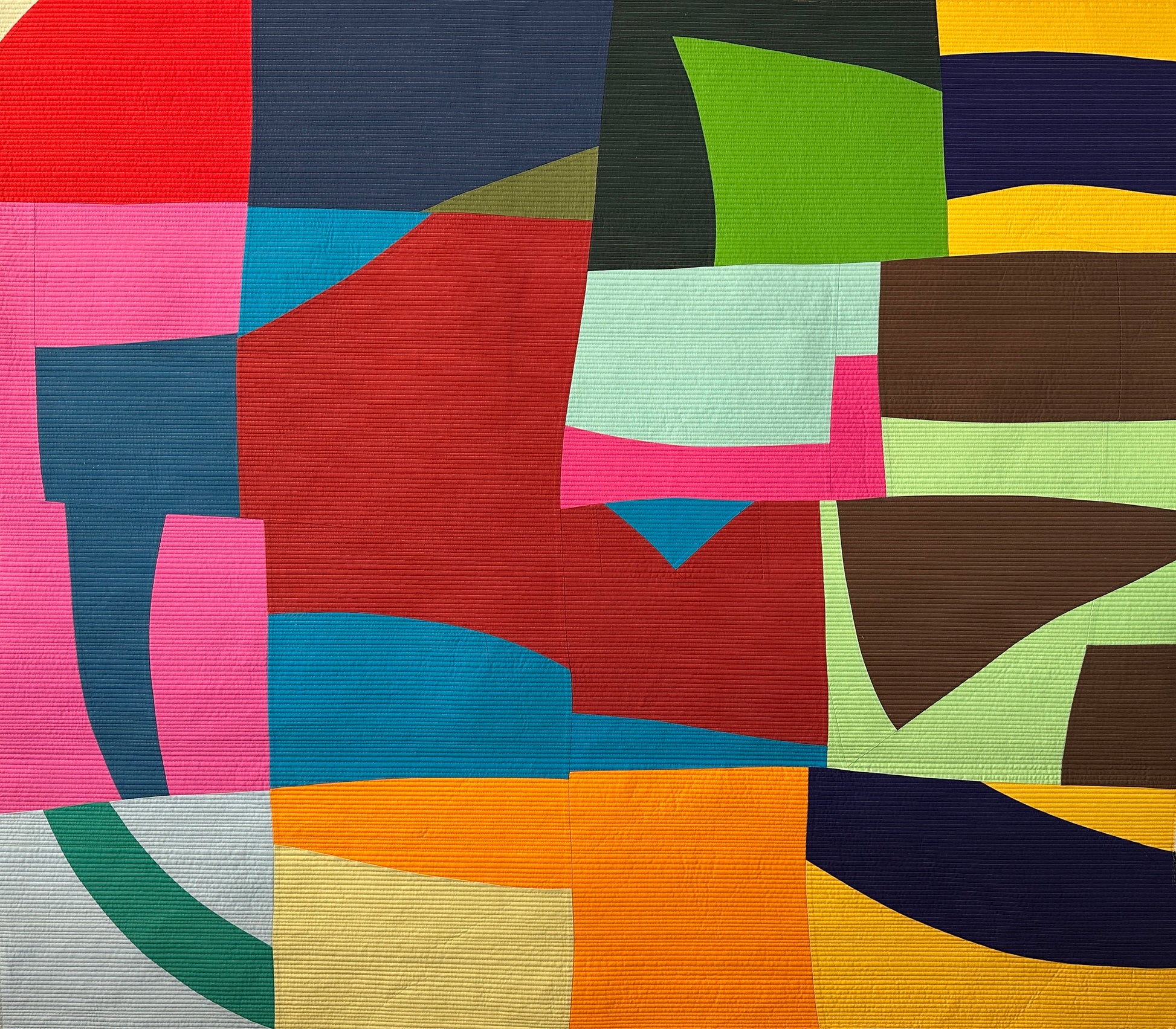 Colorful abstract art quilt with bold geometric shapes
