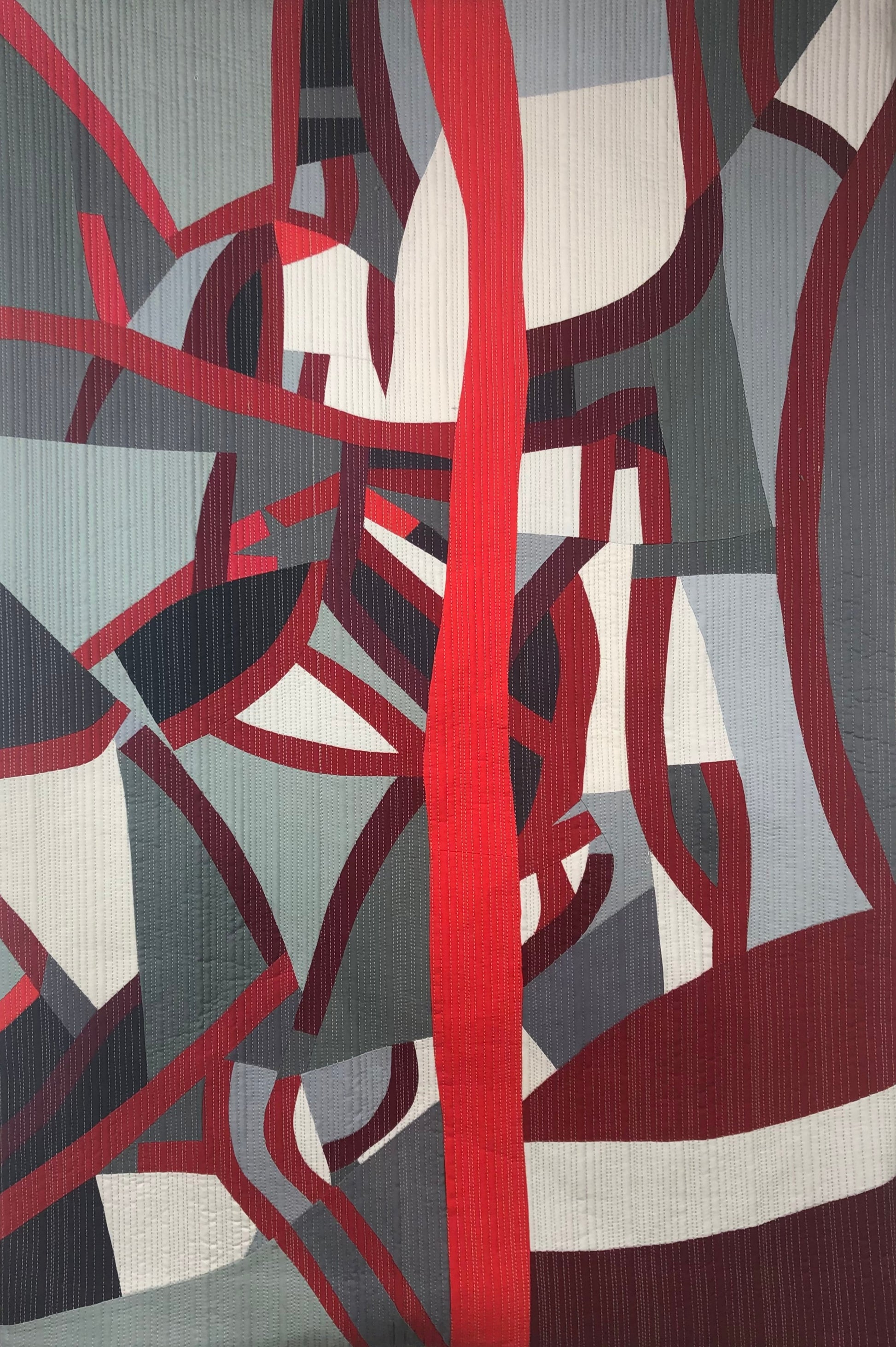 Abstract art quilt with red, gray, and white colors depicting the Hudson River watershed as blood vessels