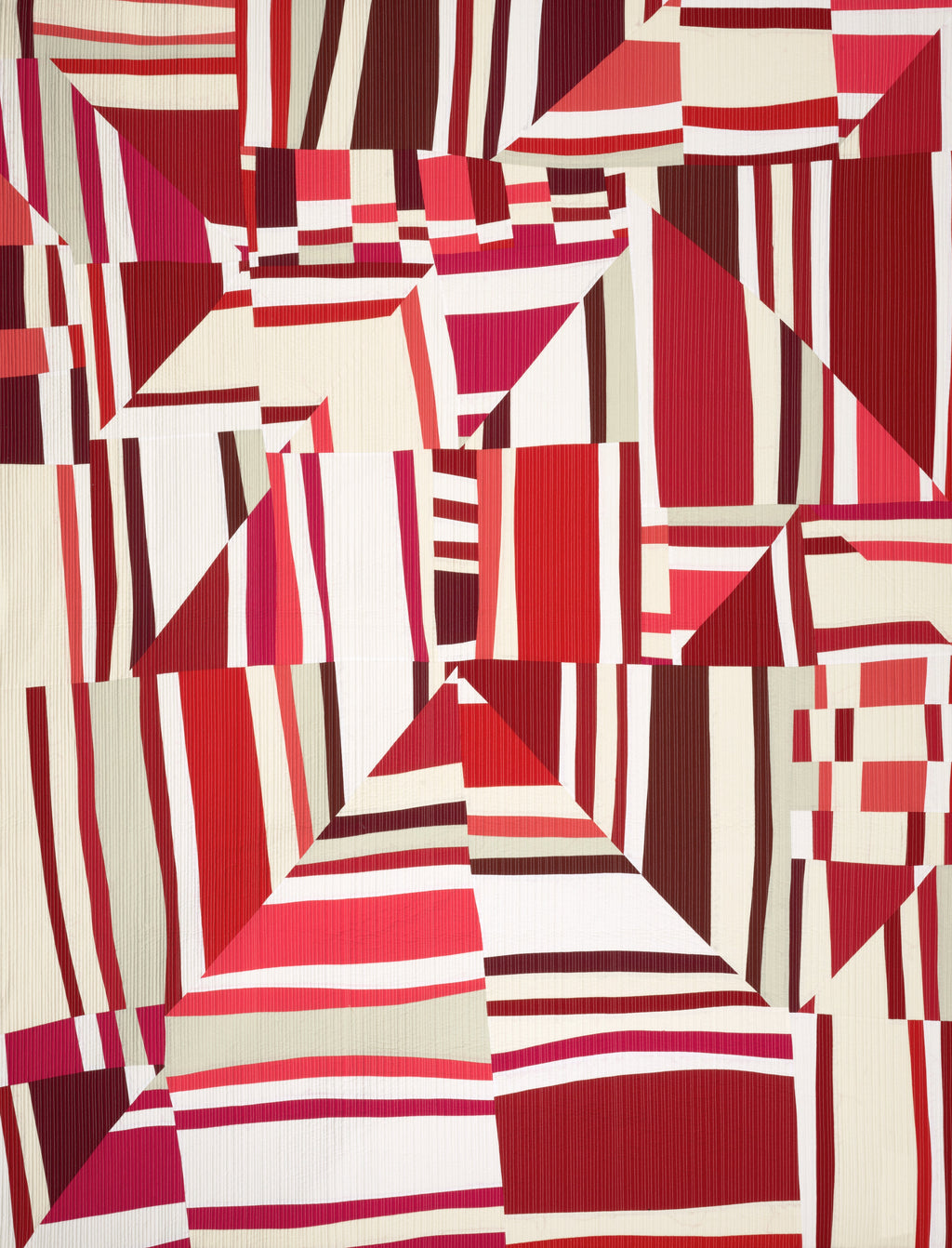 Art quilt with geometric patterned fabric with red and white squares and triangles
