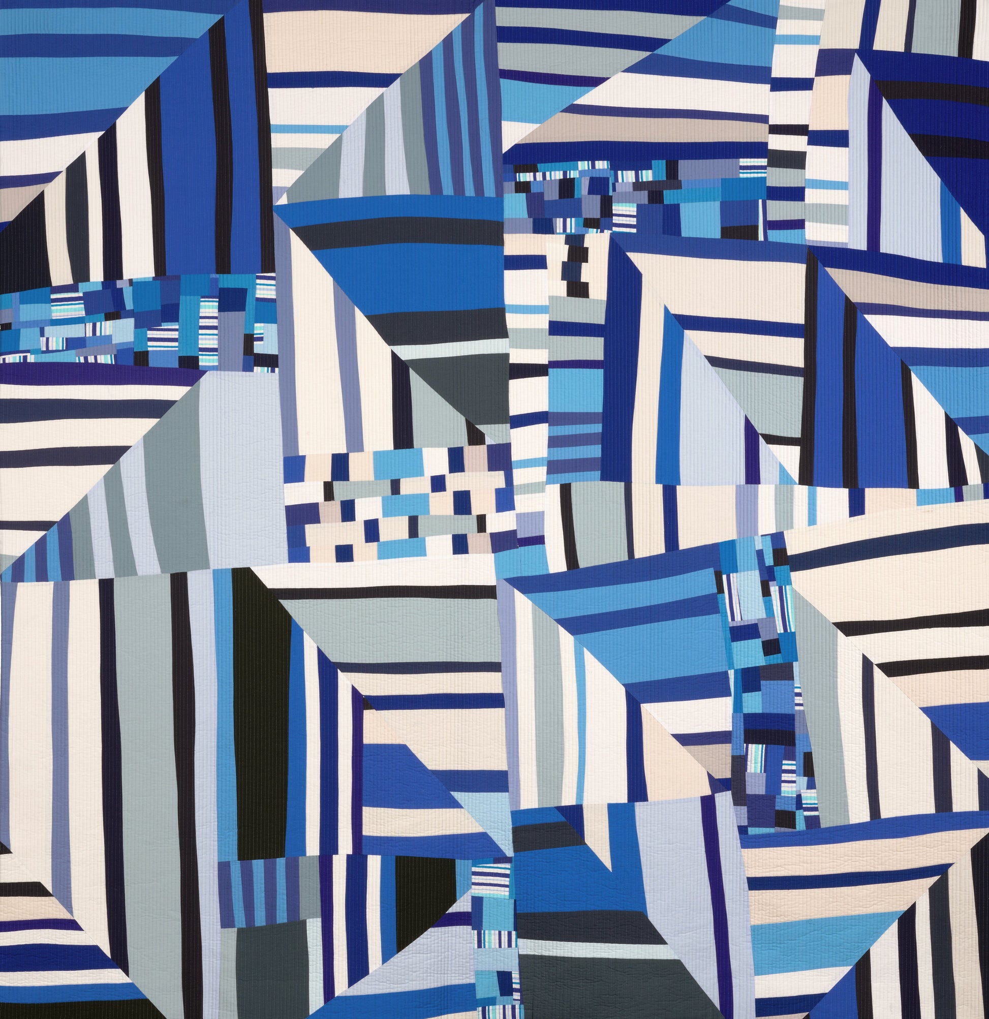 Art quilt with abstract geometric pattern with blue, and white colors on a fabric background