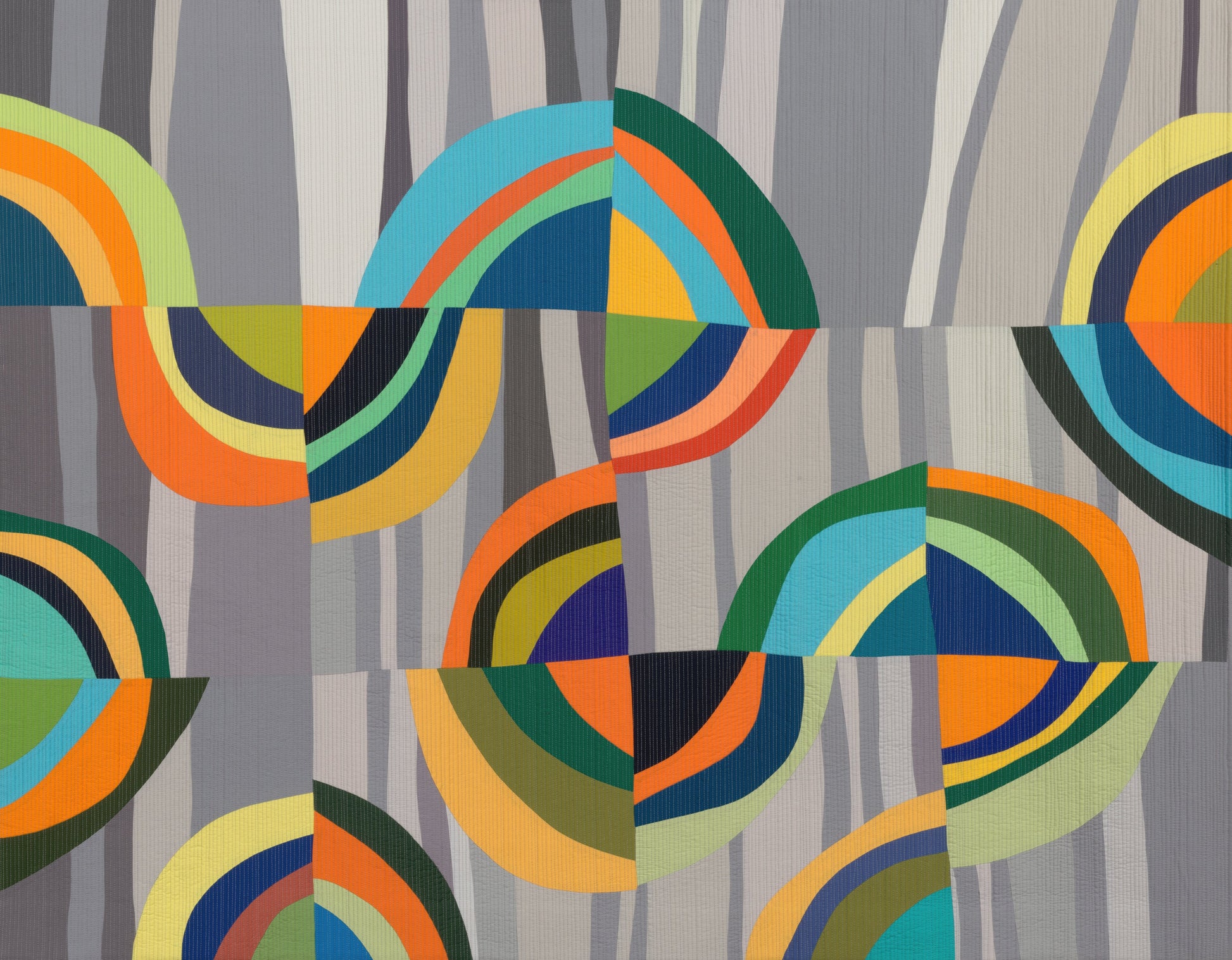Colorful geometric patterned art quilt with circular shapes on a gray background