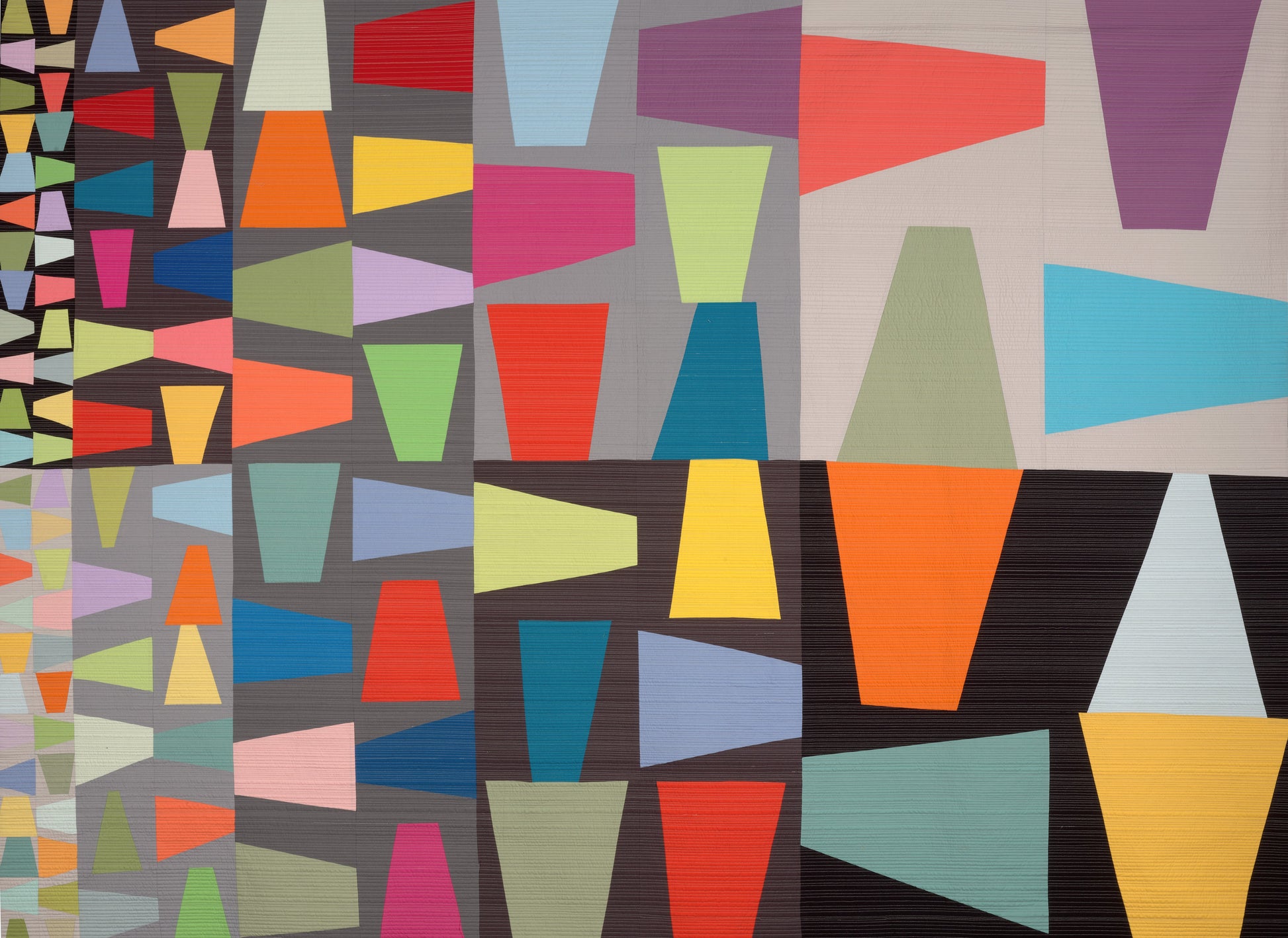 Colorful geometric patterned art quilt with trapezoidal shapes