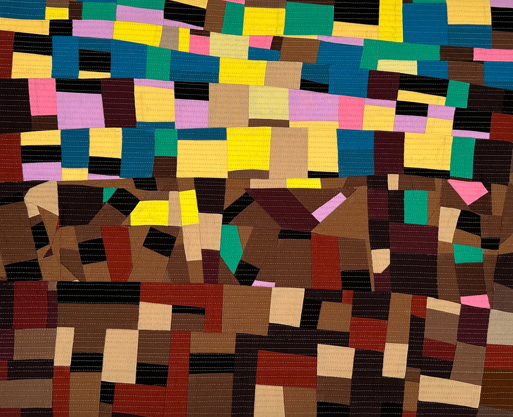 Multicolored geometric patterned art quilt with sedimentary layers of shapes and colors.